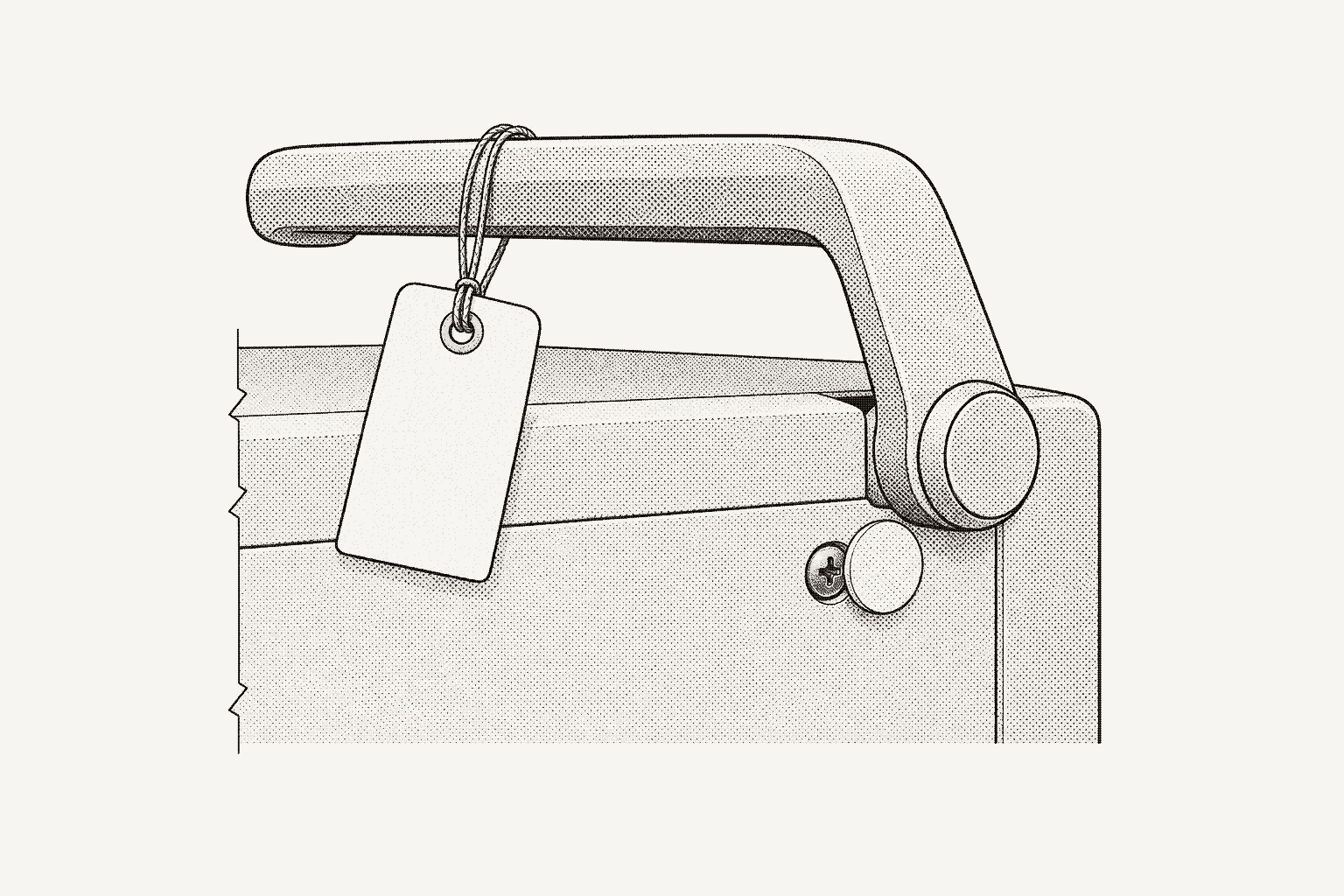 Close-up of an instrument's carrying handle with a blank tag tied on and a round seal over one panel screw.