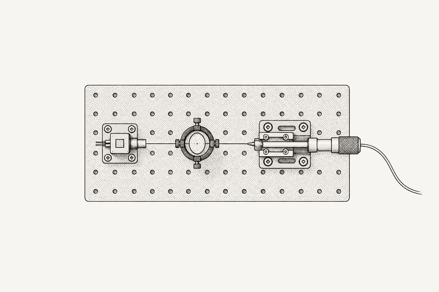 A photonics alignment bench seen from above: laser chip, lens and fibre on a translation stage along one beam line.